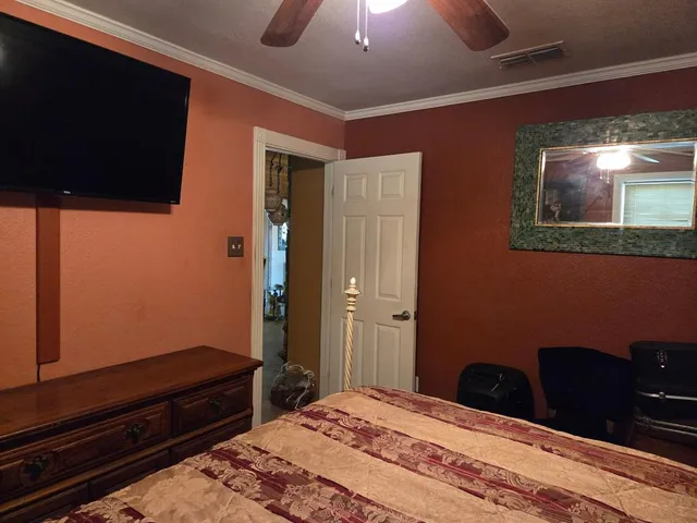 a bedroom with a bed and a desk