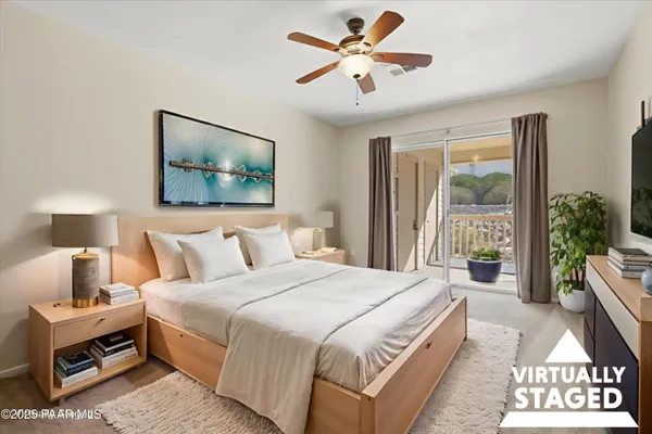 a spacious bedroom with a bed a couch and a window