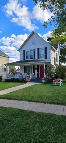 a front view of a house with a yard table and chairs