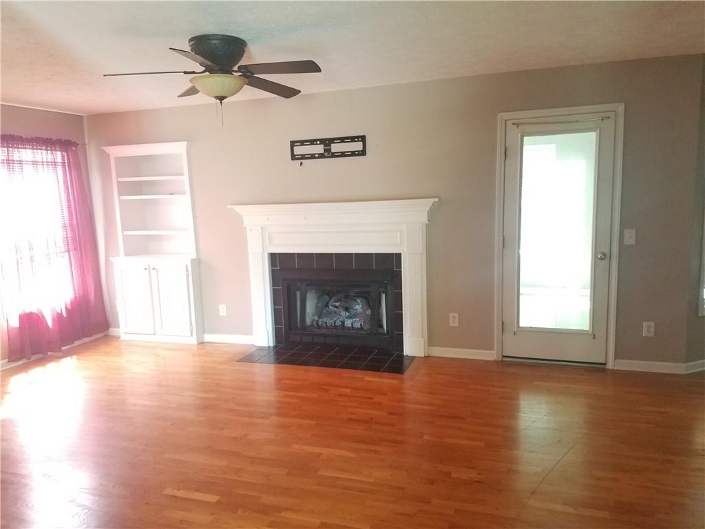 200 Jacksons Run Morganton, NC 28655 - Photo 3 of 7 a view of an empty room with wooden floor fireplace and a window