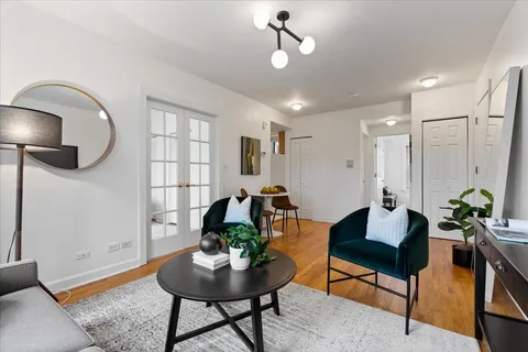 a living room with furniture and a wooden floor