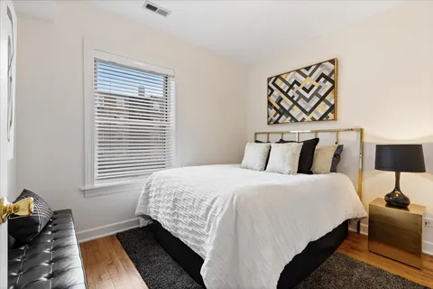 a bedroom with bed and a night stand