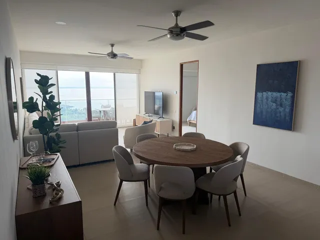 a view of a dining room with furniture and window