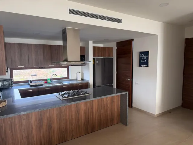 a kitchen with stainless steel appliances granite countertop a refrigerator and a stove