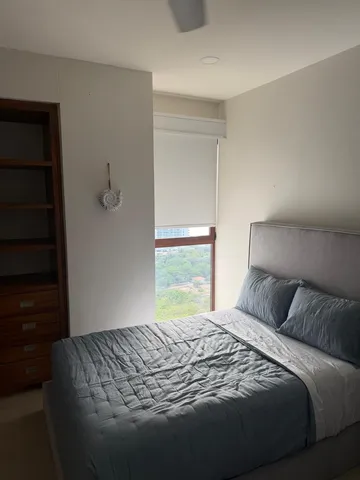 a bedroom with a bed and a window