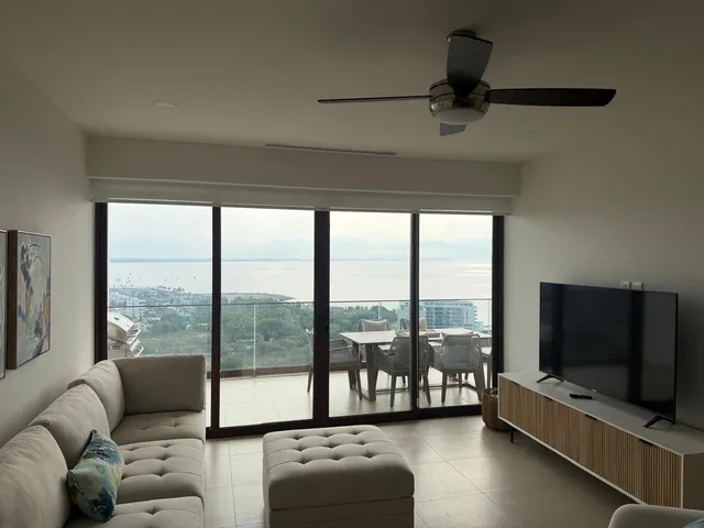 a living room with furniture and a flat screen tv