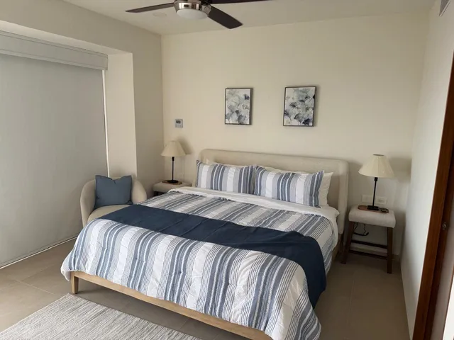 a bedroom with a bed and painting on the wall