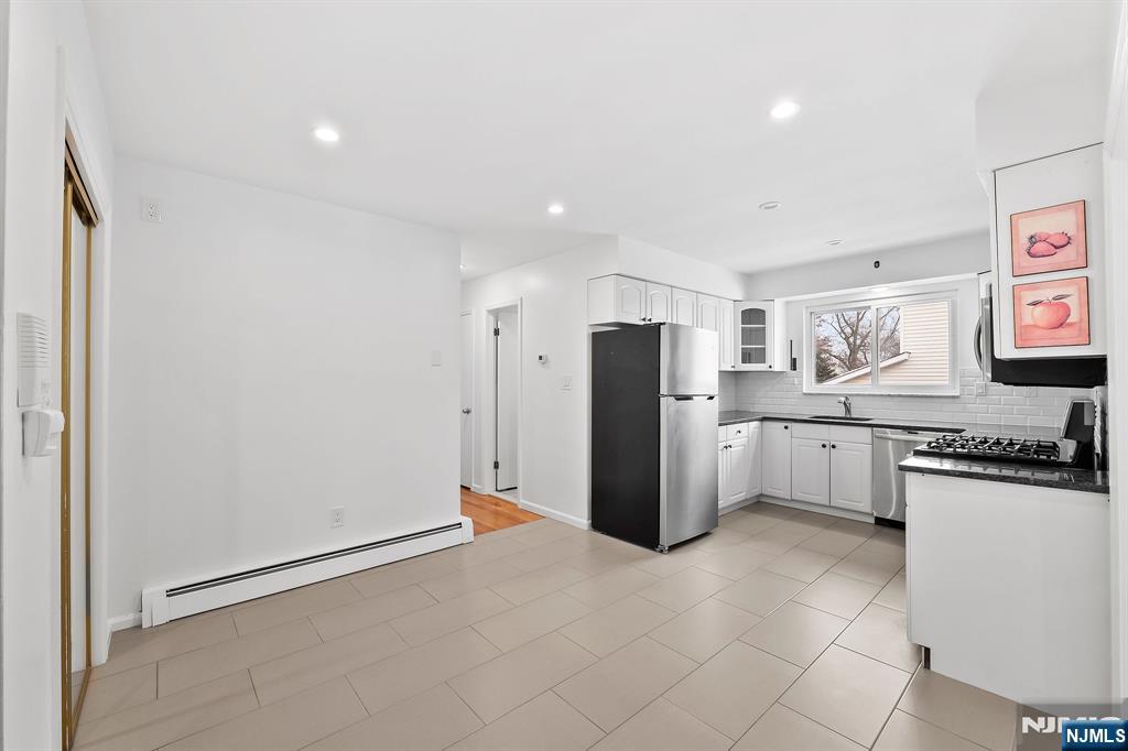 198 Conover Avenue, Unit 4 Nutley, NJ 07110 - Photo 2 of 17 a kitchen with stainless steel appliances a refrigerator and a stove top oven
