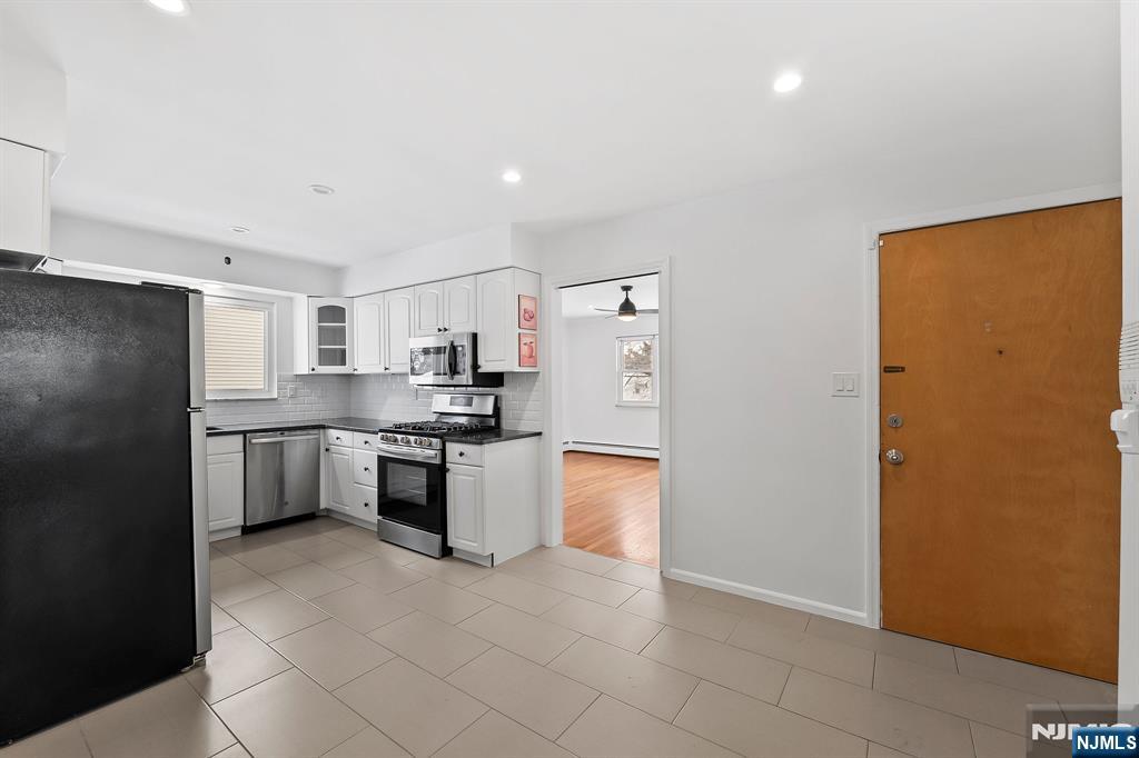 198 Conover Avenue, Unit 4 Nutley, NJ 07110 - Photo 3 of 17 a kitchen with stainless steel appliances granite countertop a refrigerator a stove and a sink