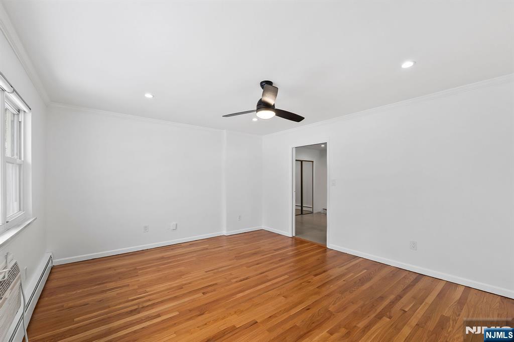 198 Conover Avenue, Unit 4 Nutley, NJ 07110 - Photo 6 of 17 a view of empty room with wooden floor and fan