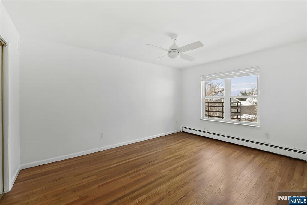 198 Conover Avenue, Unit 4 Nutley, NJ 07110 - Photo 9 of 17 wooden floor in an empty room with a window