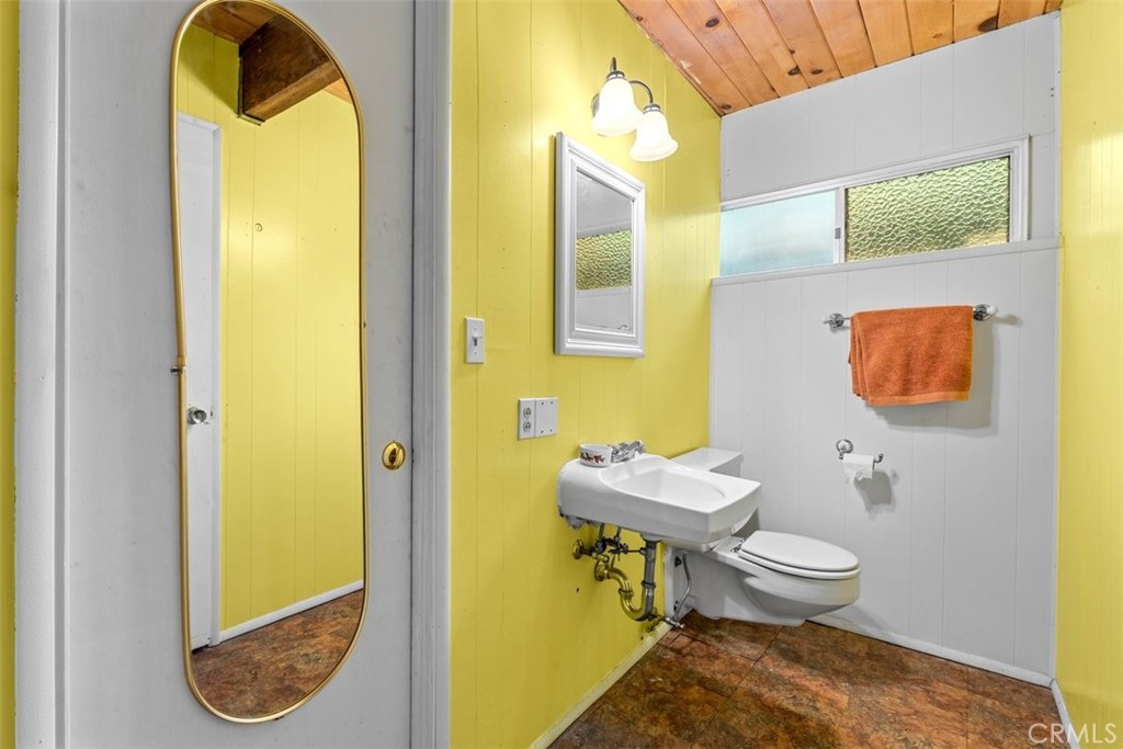 26305 Jacqueline Road Twin Peaks, CA 92391 - Photo 17 of 33 a bathroom with a toilet sink and mirror