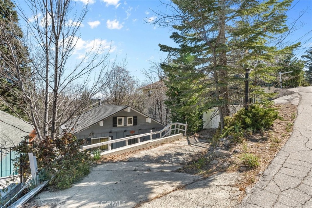 26305 Jacqueline Road Twin Peaks, CA 92391 - Photo 19 of 33 a house with trees in front of it
