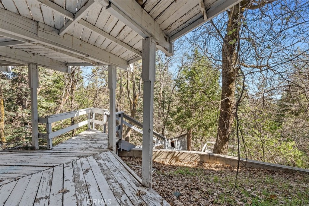 26305 Jacqueline Road Twin Peaks, CA 92391 - Photo 22 of 33 a view of a porch with wooden floor and bench