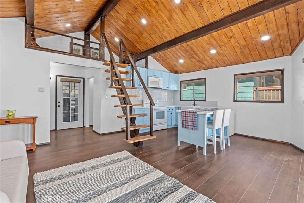26305 Jacqueline Road Twin Peaks, CA 92391 - Photo 6 of 33 a view of an empty room with wooden floor and stairs