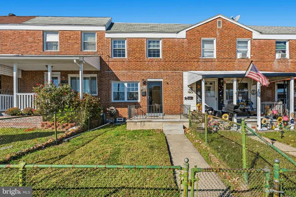 front view of a brick house with a yard