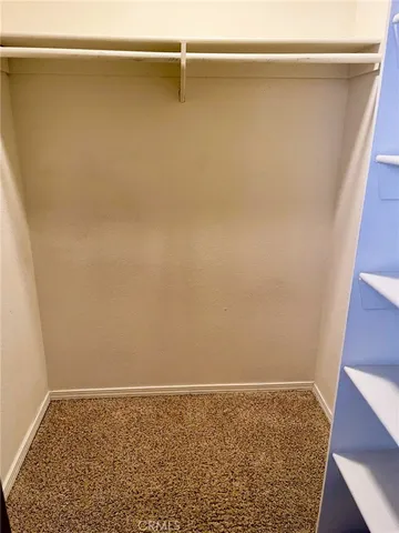 a view of closet with wooden floor