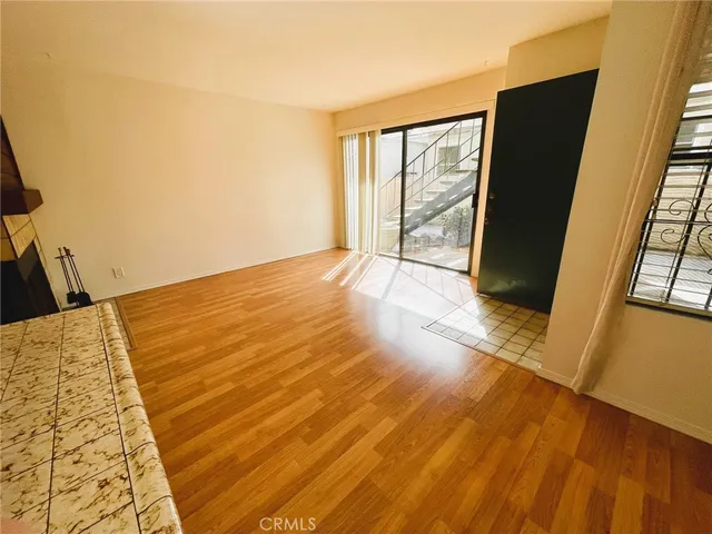 a view of an empty room and wooden floor