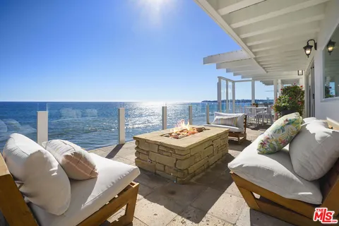 an aerial view of house with ocean view