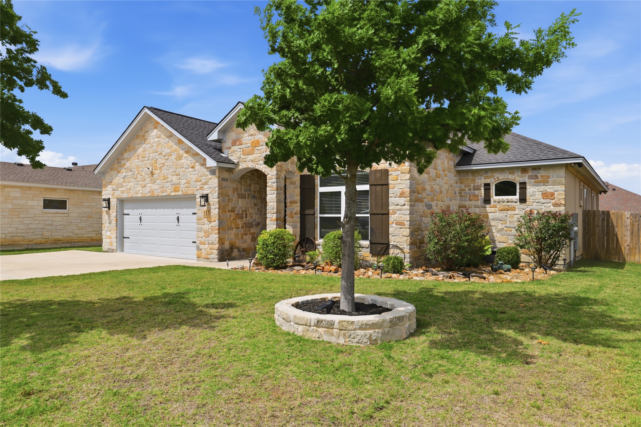 133 Greg Lane Jarrell, TX 76537 - Photo 2 of 24 Stone-clad exterior featuring a gabled roofline and attached two-car garage