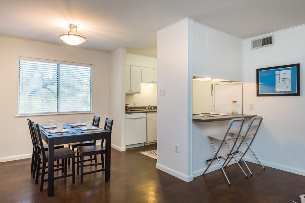 3914 Avenue D, Unit 201 Austin, TX 78751 - Photo 3 of 8 a view of a dining room with furniture and wooden floor