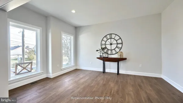a view of a livingroom with wooden floor and a window