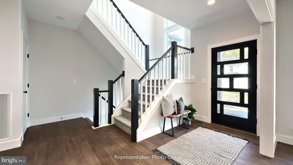 a view of entryway with stairs and wooden floor