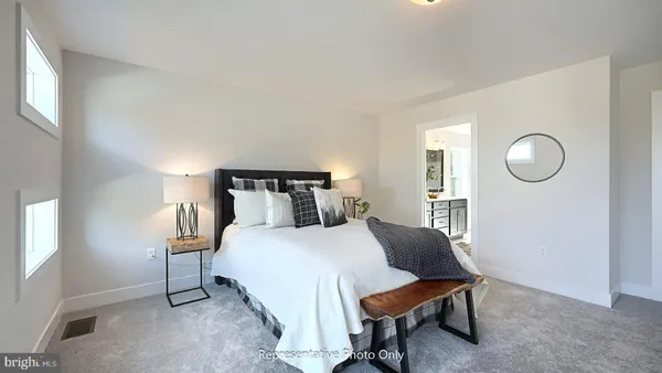 a bedroom with a bed a mirror and a window