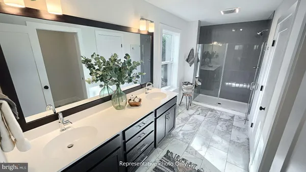 a bathroom with a sink a mirror and a shower
