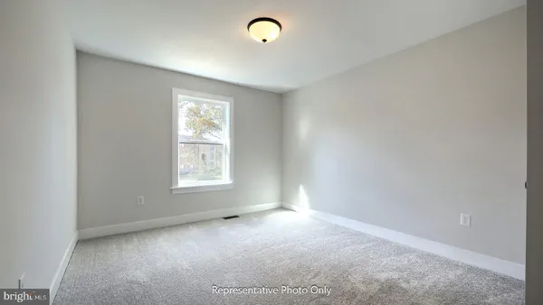 a view of empty room with window and fireplace