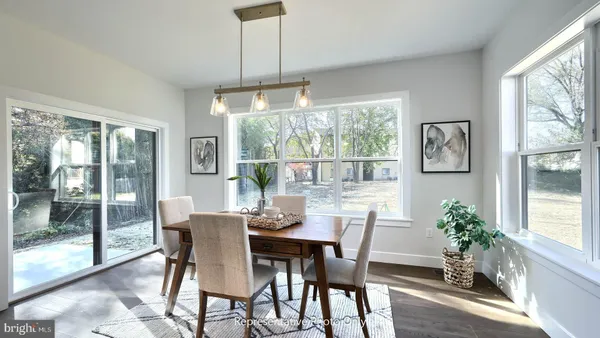 a dining room with furniture window and wooden floor