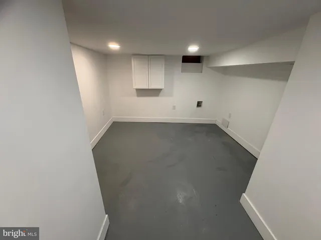 an empty room with a empty space and windows