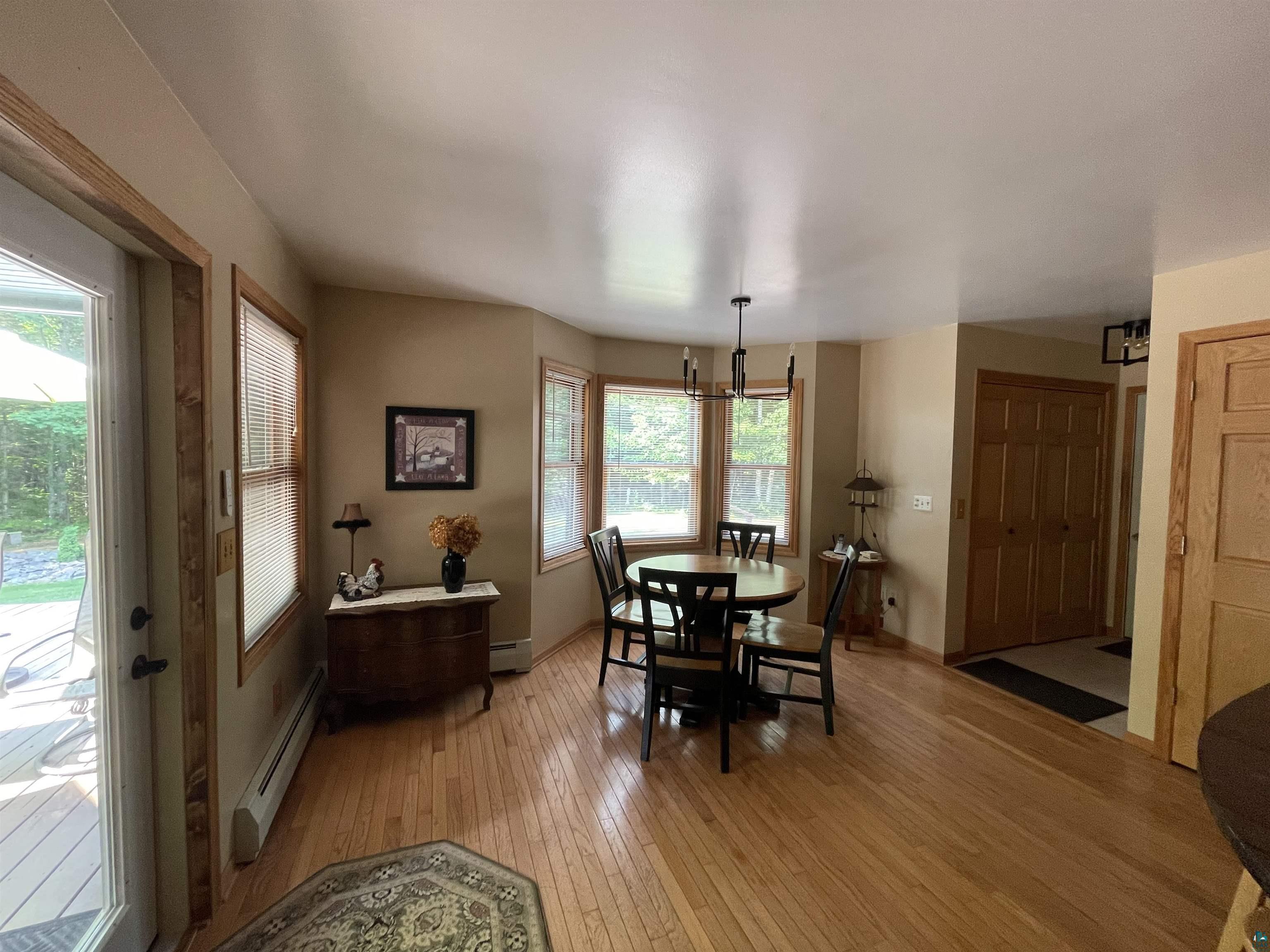 84830 Old San Road Bayfield, WI 54814 - Photo 4 of 30 Hardwood-finish flooring, bay window, natural wood trim, double closet doors, and outdoor deck access
