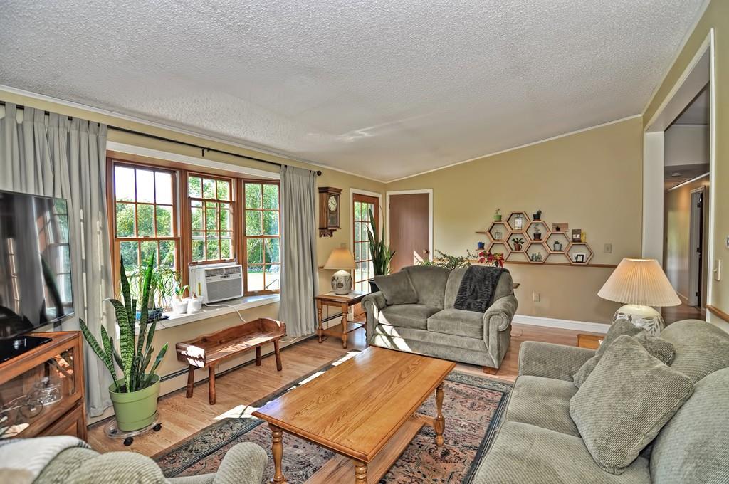 16 B Mullin Hill Road, Unit B Little Compton, RI 02837 - Photo 11 of 19 a living room with furniture and a flat screen tv