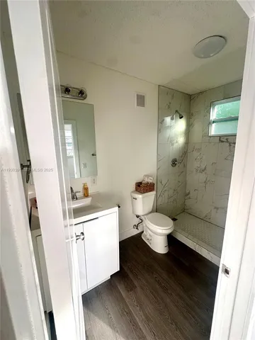 a bathroom with a toilet a sink and a mirror