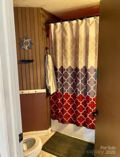 a bathroom with a bathtub and shower