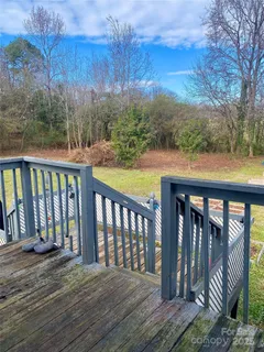 a balcony with wooden floor and fence