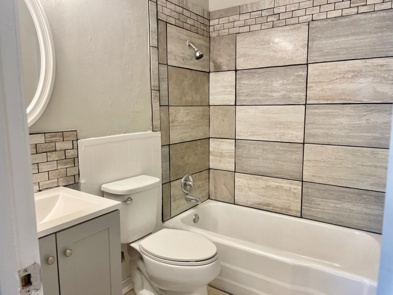 5416 45th Street Lubbock, TX 79414 - Photo 12 of 19 a bathroom with a toilet and a bathtub