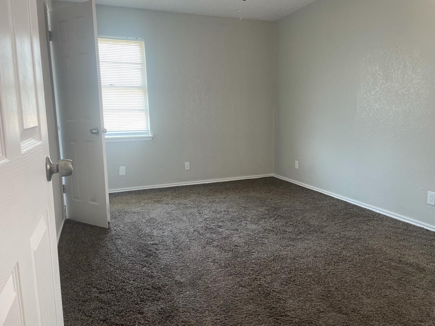 5416 45th Street Lubbock, TX 79414 - Photo 13 of 19 an empty room with a window