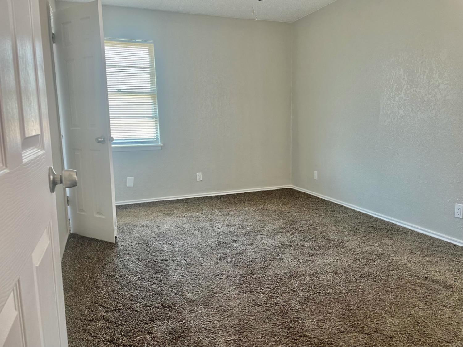 5416 45th Street Lubbock, TX 79414 - Photo 16 of 19 an empty room with windows