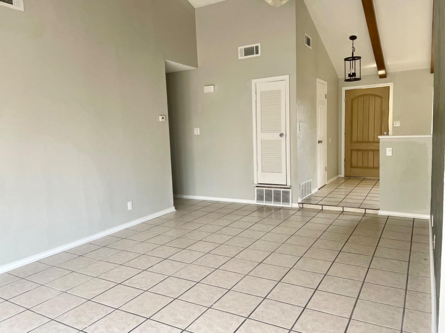 5416 45th Street Lubbock, TX 79414 - Photo 4 of 19 an empty room with entrance and mirror