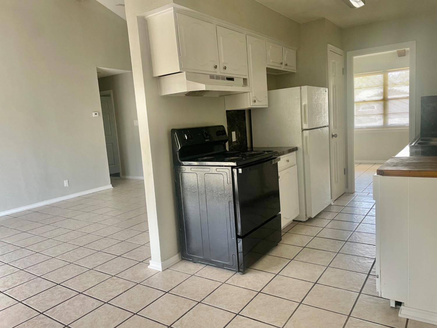 5416 45th Street Lubbock, TX 79414 - Photo 5 of 19 a kitchen with stainless steel appliances granite countertop a refrigerator and a stove