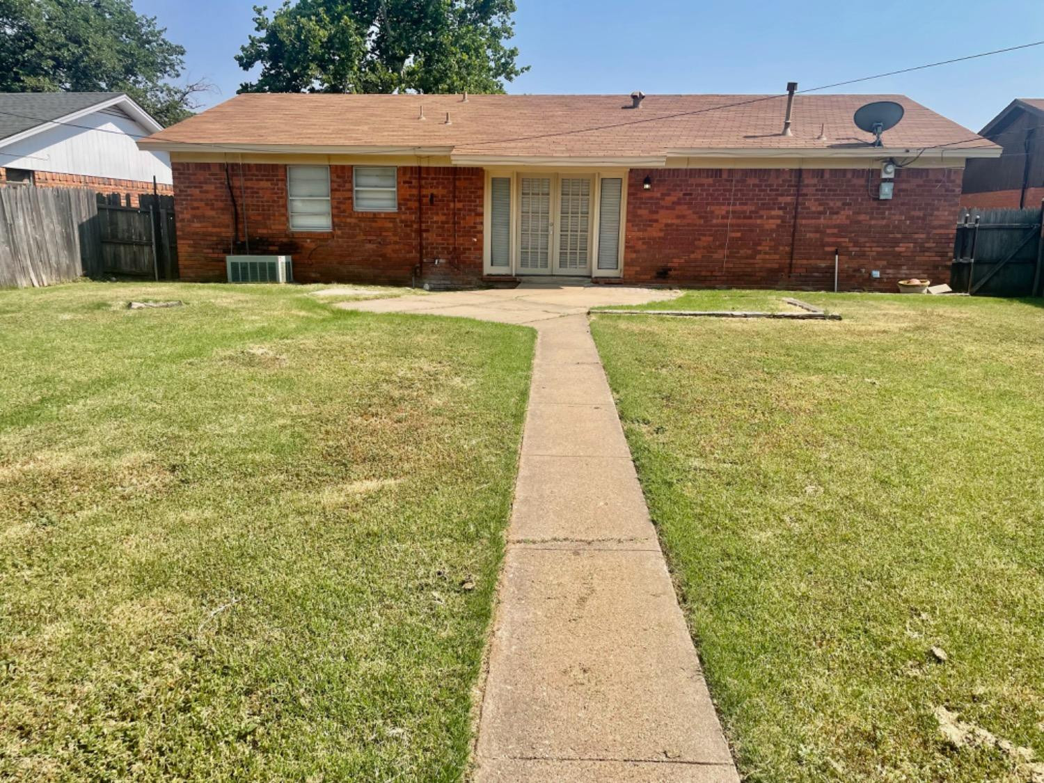 5416 45th Street Lubbock, TX 79414 - Photo 7 of 19 a front view of a house with a yard