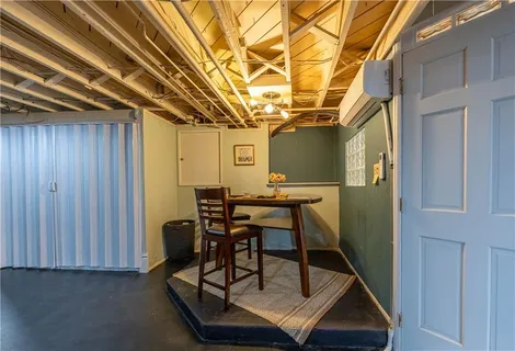 a view of a room with a table and chairs