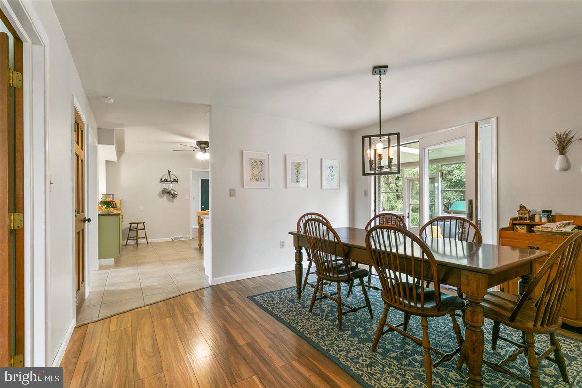 44 Green Acre Road Lititz, PA 17543 - Photo 34 of 66 a view of a dining room and livingroom with furniture wooden floor a chandelier