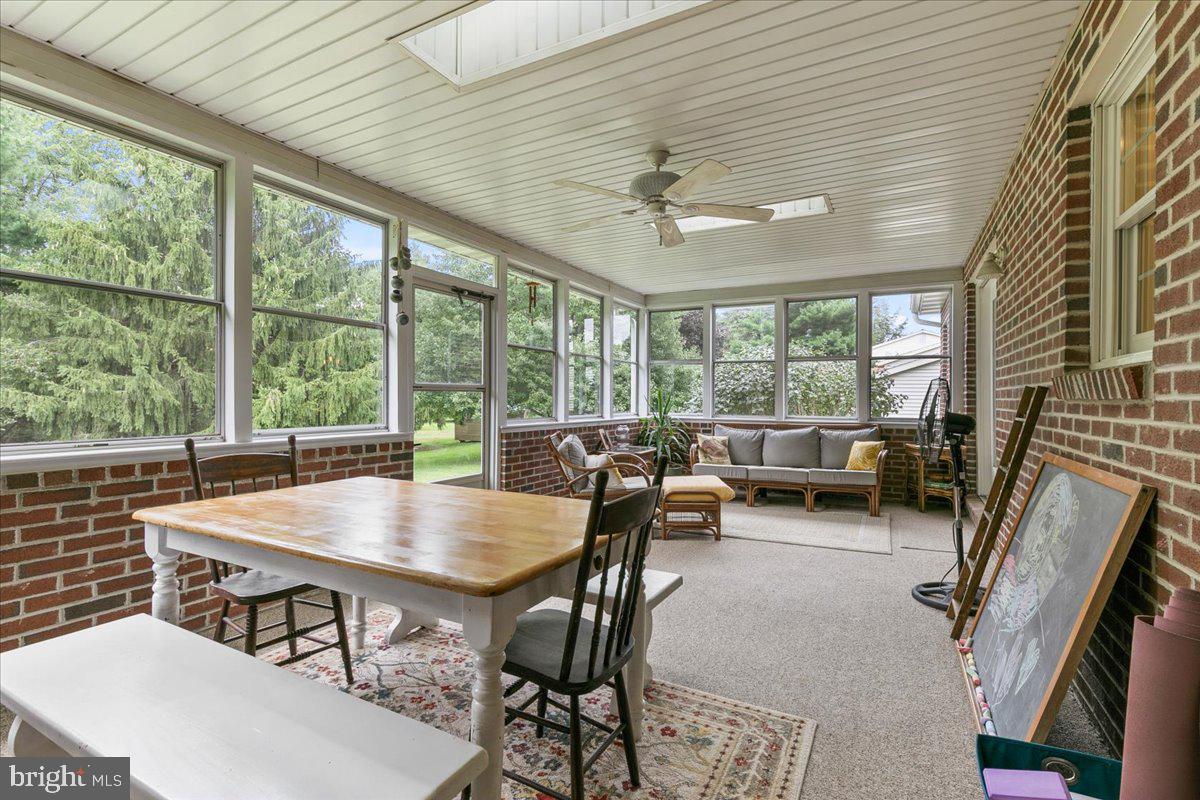 44 Green Acre Road Lititz, PA 17543 - Photo 36 of 66 a view of a dining room with furniture large windows and wooden floor
