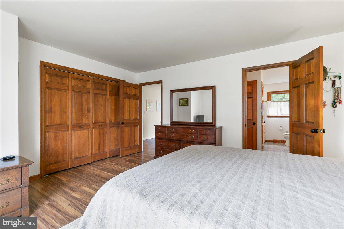 44 Green Acre Road Lititz, PA 17543 - Photo 40 of 66 a bedroom with a large bed and wooden floor