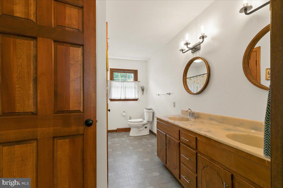 44 Green Acre Road Lititz, PA 17543 - Photo 42 of 66 a bathroom with a sink a toilet and a mirror