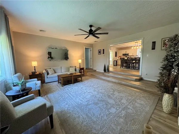 a living room with furniture and a chandelier