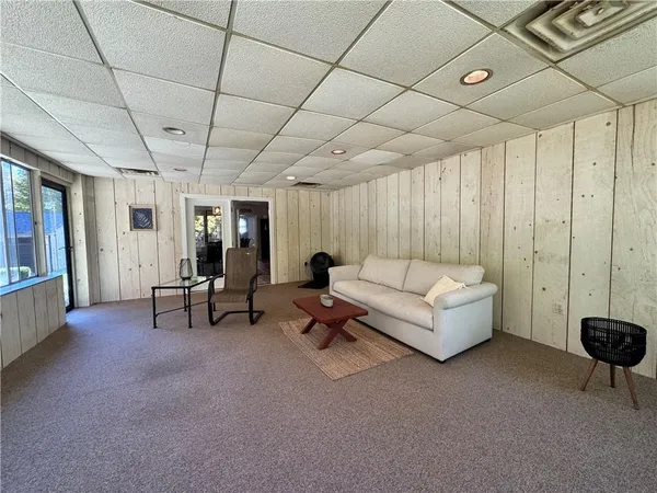 a living room with furniture and a chandelier